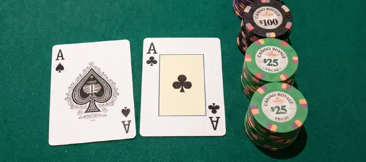 two aces and casino chips on a poker table  