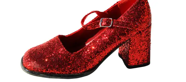 Wizard and good fairy standing next to representation of Oz