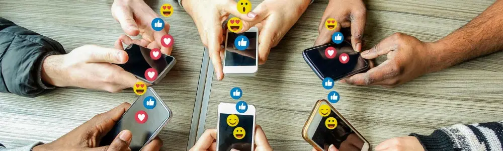 mobile phone users on their phones with social media emojis emerging